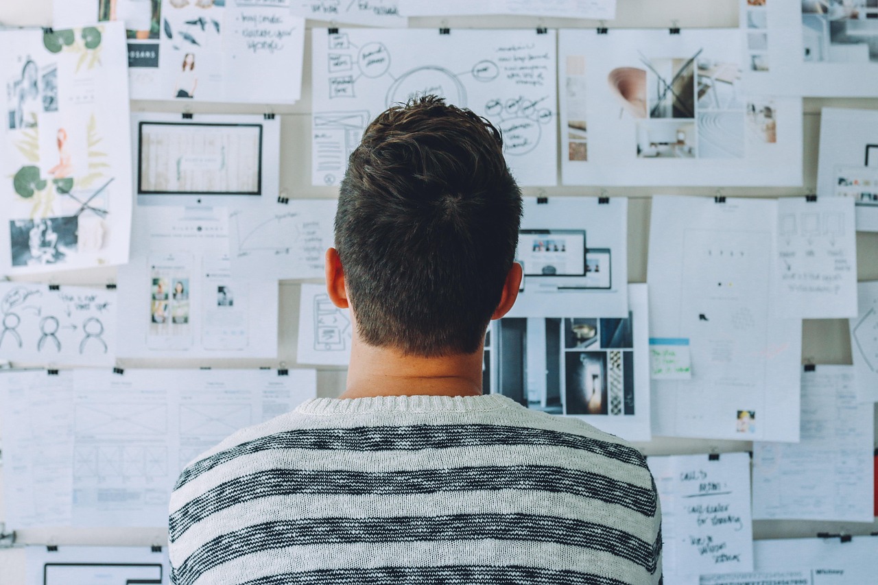 Person presenting at a whiteboard in an office planning session