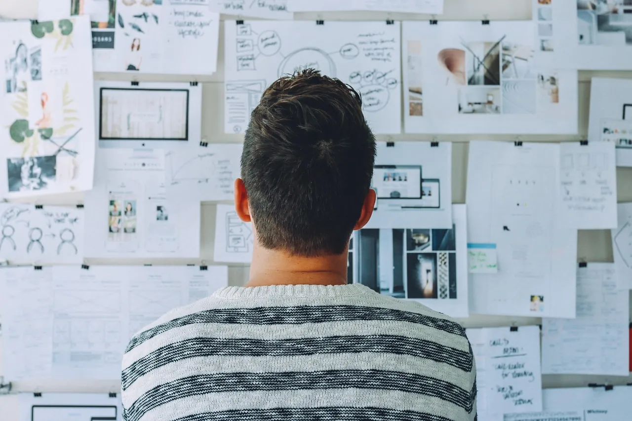 Person presenting at a whiteboard in an office planning session